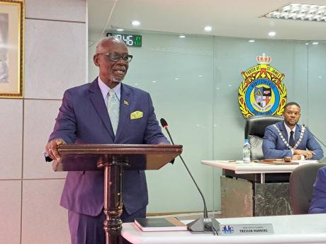 Local Government Minister Desmond McKenzie (left) addresses the monthly meeting of the St James Municipal Corporation on Thursday, while Montego Bay Mayor Richard Vernon looks on.