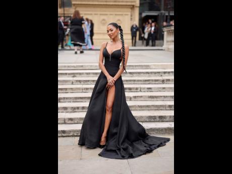 Nicole Scherzinger showing a lot of leg in a daring, well-fitting black gown.