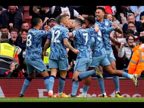 Aston Villa’s Leon Bailey (second right) celebrates with teammates after scoring his side’s opening goal during the English Premier League  match between Arsenal and Aston Villa at the Emirates stadium in London yesterday.