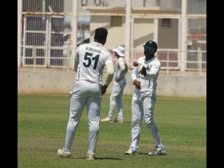 Guyana Harpy Eagles spinner Veerasammy Permaul (right) throws the ball to pacer Ronaldo Alimohamed during second-day action of their West Indies Championship encounter against the Jamaica Scorpions at Sabina Park on Thursday. 