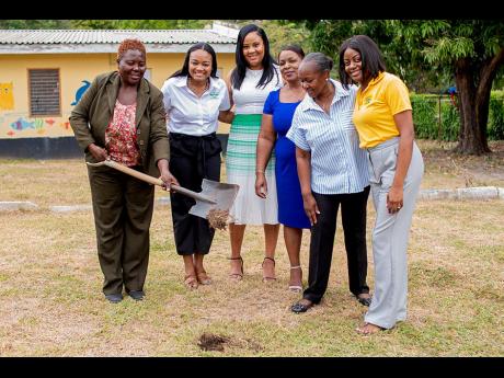 Paulette Dyer (left), acting principal, Little Angels Learning Centre at the Mustard Seed Jerusalem Children’s Home, does the symbolic groundbreaking at the Jamaica National Children’s Home in St Andrew during a recent ceremony with stakeholders from t