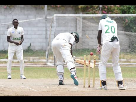 St George’s College’s Demario Thorpe (centre) is bowled by Excelsior High School’s Tamarie Redwood (left) during their ISSA GK Insurance Urban T20 semifinal at Emmett Park yesterday. 