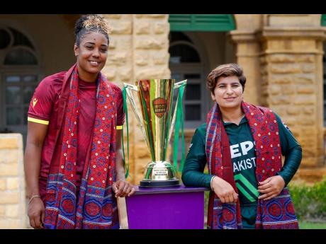 West Indies Women’s captain Hayley Matthews (left) and Pakistan  skipper Nida Dar pose with the trophy up for grabs in an ODI series between the teams at the Quaid-e-Azam House recently.