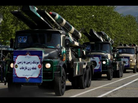 Missiles are carried on trucks during Army Day parade at a military base in northern Tehran, Iran.