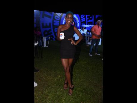 Blue-haired and vibrant, Antoneil Dinnall, brand coordinator for Pepsi Jamaica, put her brand on display. 