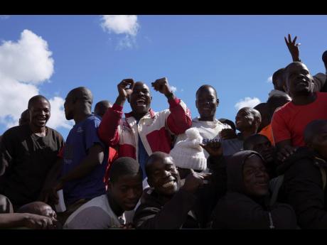 Prisoners celebrate after being released from Chikurubi Maximum prison on the outskirts of the capital Harare, Thursday, April 18. 
