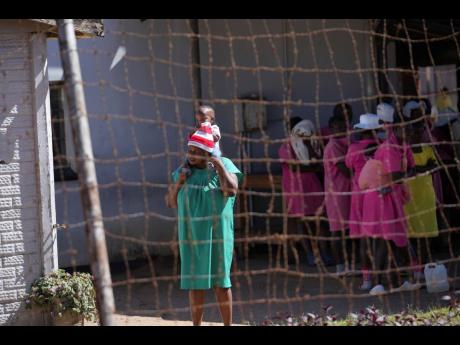 A female prisoner holds her baby inside Chikurubi female prison on the outskirts of the capital Harare, Thursday, April 18. 