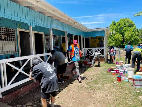 Volunteers painting the Boscobel Primary & Infant School’s infant department in St Mary on Monday.
