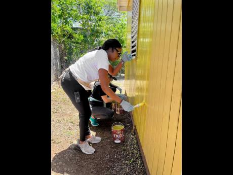 Ronnie Tomlinson, director of public relations for the Love and Harmony Cruise, playing her part with the repainting of Boscobel Primary and Infant School’s infant department in St Mary on Monday.