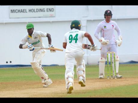 Jamaica Scorpions batsman Kirk McKenzie  (left) takes the two runs which brought up his half-century against the Trinidad & Tobago Red Force at Sabina Park yesterday. At centre is his teammate Abhijai Mansingh while at right is  Trinidad & Tobago Red Force