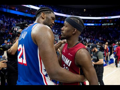 Philadelphia 76ers’ Joel Embiid (left) talks with Miami Heat’s Jimmy Butler following an NBA basketball play-in tournament game Wednesday, April 17, 2024, in Philadelphia. 
