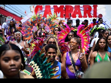 Xodus revellers crossing the stage on Trafalgar Road at the Jamaica Carnival road march. 