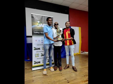 The National Collegiate Debating Championship’s winning team of University of Technology, Jamaica final-year bachelor of Law students Enroy Madourie (left) and Jadon Hewitt (right). At centre is Germaine Barrett, convenor of the competition. 