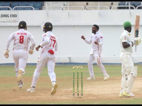 Trinidad and Tobago Red Force spinner Bryan Charles (third left) celebrates after picking up the wicket of Jamaica Scorpions batsman Romaine Morris on yesterday’s third day of their West Indies Championship final-round game at Sabina Park. 