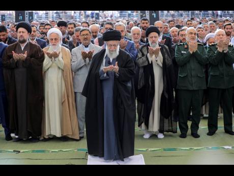In this photo released by an official website of the office of the Iranian supreme leader, Supreme Leader Ayatollah Ali Khamenei leads Eid al-Fitr prayer marking the end of the Muslims holy fasting month of Ramadan in Tehran, Iran.