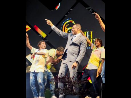 Prime Andrew Holness joined Kaka Highflames on stage to show off his dance moves.