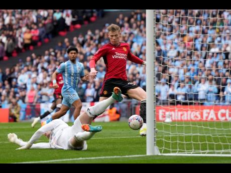 Manchester United’s Scott McTominay (right) scores his side’s opening goal during the English FA Cup semifinal  match between Coventry City and Manchester United at Wembley stadium in London yesterday.