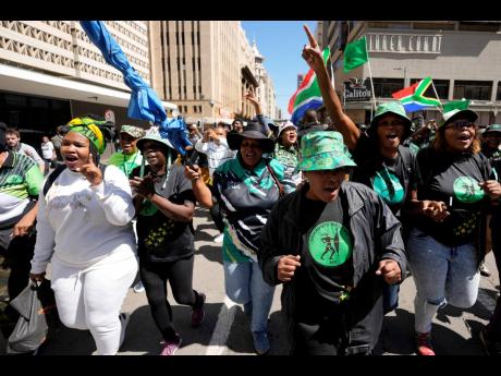Supporters of South Africa’s former President Jacob Zuma sing and dance outside the south Gauteng High court in Johannesburg, South Africa, on April 11. The ANC lost a second court case against the uMkhonto weSizwe (MK) rival party led by former Presiden