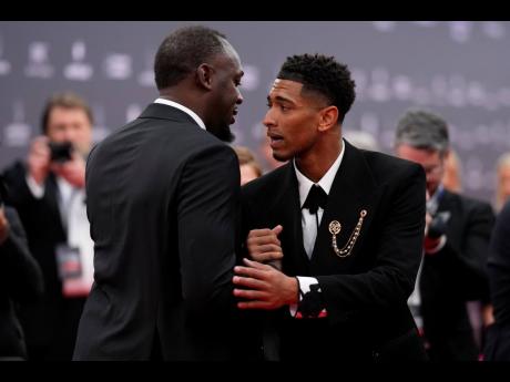 Jamaica’s Usain Bolt (left) greets Real Madrid’s Jude Bellingham before the Laureus Sports Awards ceremony in Madrid, Spain yesterday. Bellingham earned the breakthrough award at the ceremony.