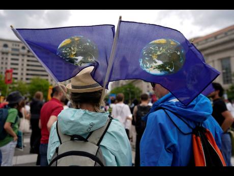 Climate activists hold a rally to protest the use of fossil fuels on Earth Day at Freedom Plaza in Washington  on April 22, 2023.