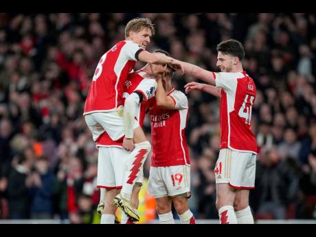 Arsenal’s Kai Havertz (right) celebrates with teammates after scoring his side’s fourth goal during the English Premier League football match against Chelsea at Emirates Stadium in London yesterday.