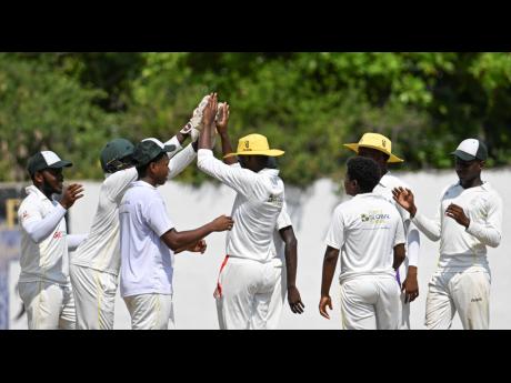 Excelsior High's players celebrate a wicket against Manchester High in the Spaulding Cup at the Melbourne Oval today. Excelsior secured an easy 256-run win to lift the title.