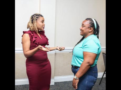 Godiva Golding, founder of STEAM House Network, and Sara-Lou Morgan-Walker, executive director of Angelic Ladies Society, have a lively discussion. 