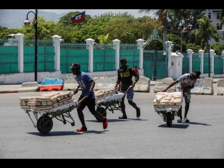 
Street vendors withdraw from the area where they were selling their bread, near the National Palace, in Port-au-Prince, Haiti, on April 2, 2024. 