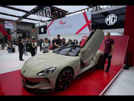 
Visitors look at an MG car during the opening of China Auto Show in Beijing, China, on Thursday, April 25, 2024.