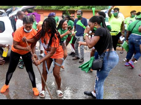 People’s National Party and Jamaica Labour Party supporters frolicking outside the Manning’s Hill Primary School in St Andrew West Rural on the day of the general election in 2020.
