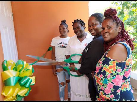 From left: Latoya Austin, a member of the community, stands proudly alongside the 2022 Supreme Hero, Jennifer Brown; Chloleen Daley-Muschett, corporate communications and PR manager at Supreme Ventures Limited; and Barbara Black, a retired teacher and dedi