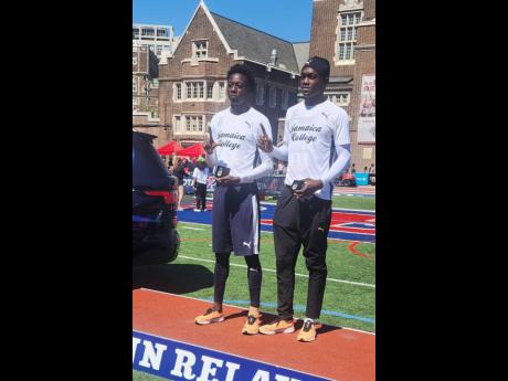 Jamaica College’s Balvin Israel (left) and Chavez Penn with their commemorative watches after wins in the long jump and triple jump respectively at the Penn Relays yesterday.