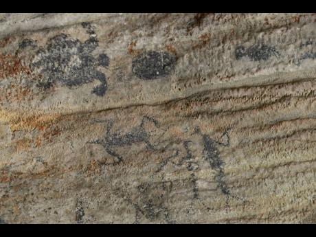 Taino rock paintings or pictographs found in the Mountain River Cave 