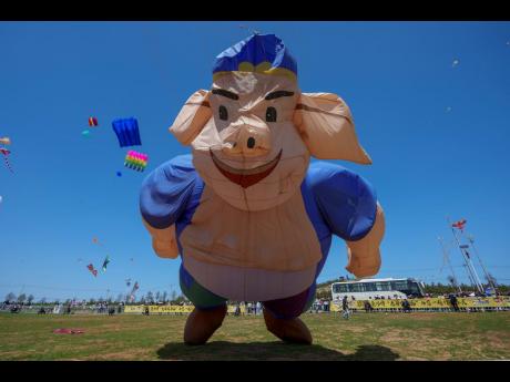 A pig-shaped kite flies at the 41st International Kite Festival.