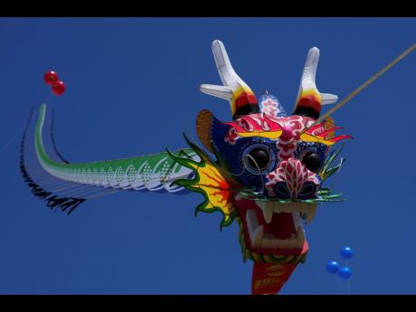 A dragon-shaped kite flies in the air at the 41st International Kite Festival.