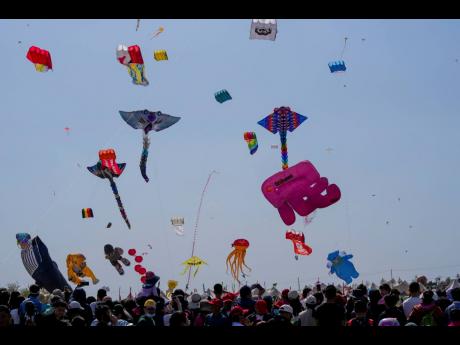 Visitors watch kites fly at the 41st International Kite Festival.