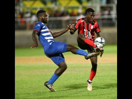 Portmore United’s Jahein Rose (left) tackles Kaheim Dixon of Arnett Gardens during their Jamaica Premier League playoff game at Sabina Park on Monday, April 22. 