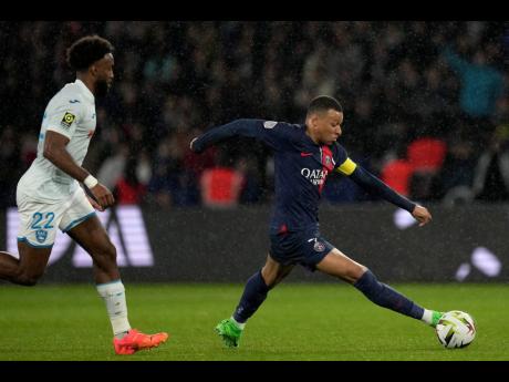 PSG’s Kylian Mbappe gets away from Le Havre’s Yoann Salmier during the French League One match between Paris Saint-Germain and Le Havre at the Parc des Princes in Paris on  Saturday, April 27, 2024. 