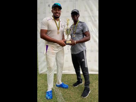  Kingston CC’s captain Akim Fraser (left) and coach Terrence Corke with the Senior Cup at the end of the two-day final at Sabina Park yesterday.