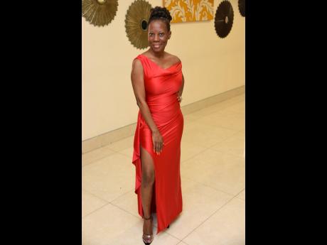 Charlene Porteous, head of the banking department at the Bank of Jamaica, is the picture of elegance in this red front-split dress.