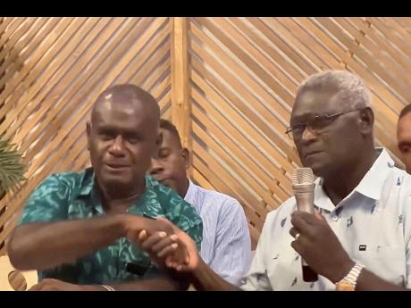 Outgoing Solomon Islands Prime Minister Manasseh Sogavare (right) and candidate for prime minister, Jeremiah Manele, shake hands during a news conference in Honiara, Solomon Islands, yesterday. 