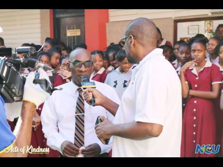  Paul Adams, principal of the Herbert Morrison Technical High School, is interviewed by  Arnold Kelly, general manager, NCU Media Group, during an Acts of Kindness School Tour. 