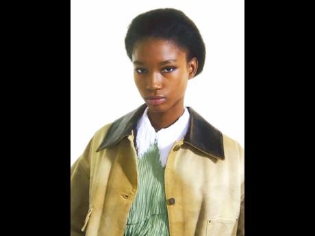 The teen from Belmont District, Clarendon, sports a Prada hand-treated cotton and patinated leather Caban jacket paired with an agave green viscose fringe shirt.