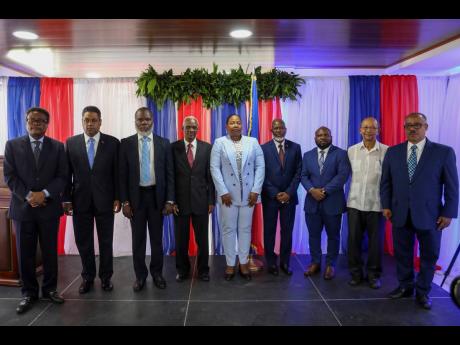 Transitional council members pose for a group photo after a ceremony to name its president and a prime minister in Port-au-Prince, Haiti, yesterday. 