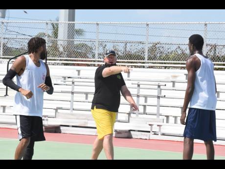 National basketball head coach, Rick Turner, gives instructions to charges during a training session. 