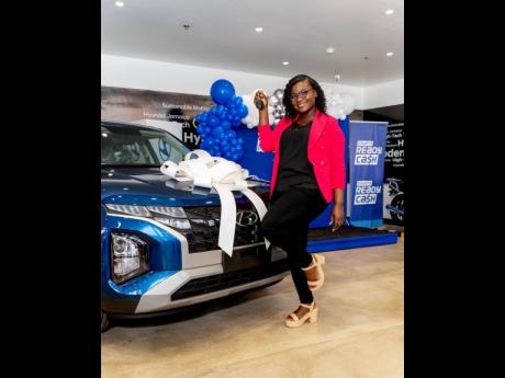 Santana Williston, winner of a new Hyundai Creta 2024 SUV in the Courts Ready Cash Big Money Move competition on Friday. The vehicle was handed over inside the showroom of Hyundai Jamaica. 
