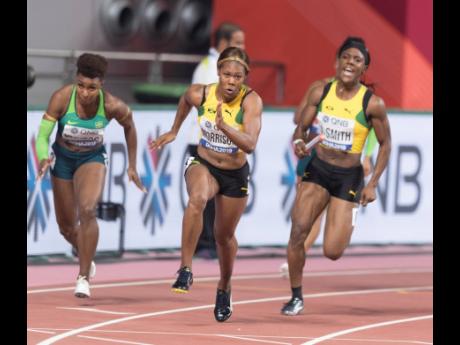 Natasha Morrison (centre) takes off before collecting the baton from third leg runner Jonielle Smith (right) at the 2019 IAAF World Athletic Championships in Doha, Qatar.