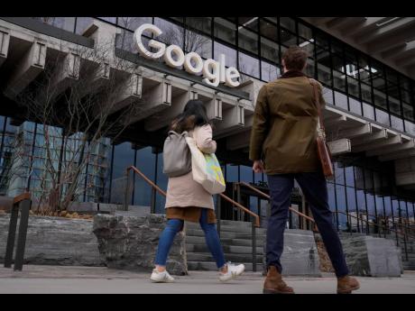 People walk nearby the recently opened Google building in New York, February 26, 2024.