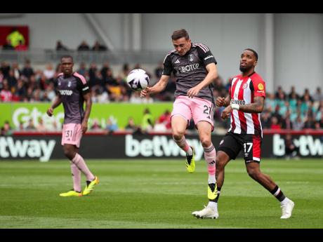 AP 
Fulham’s Timothy Castagne (centre) battles for the ball against Brentford’s Ivan Toney (right) during the English Premier League football match between the teams at the Gtech Community Stadium in London yesterday.