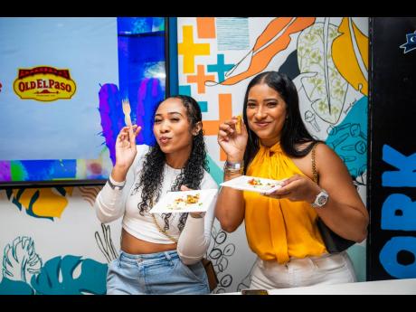 Good friends, and even better food! Danielle Armond (left) and Victoria Colahar pose as they dig into the delicious food.